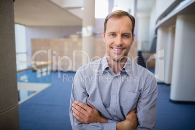 Happy businessman with arms crossed