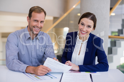 Businesswoman working at desk with colleague