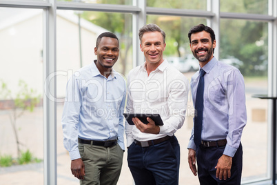 Business executives holding digital tablet
