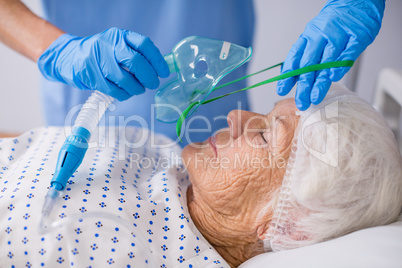 Doctor putting an oxygen mask on patient