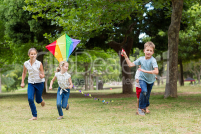 Kids playing with a kite in park