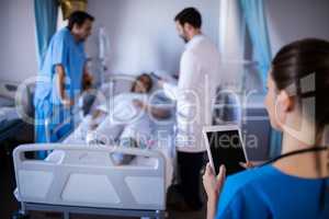 Female doctor using digital tablet in the ward