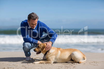 Mature man with his dog on the beach