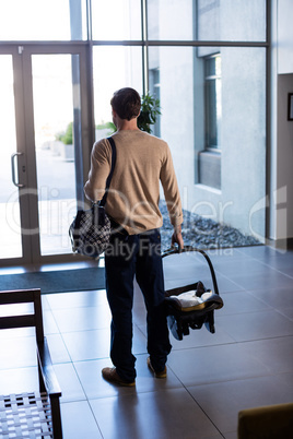 Man leaving the hospital with baby