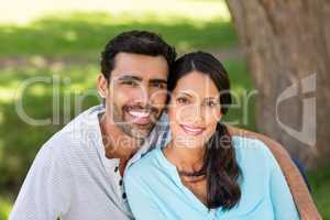 Portrait of couple sitting together in a park