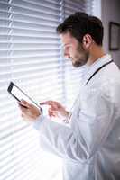 Male doctor using digital tablet