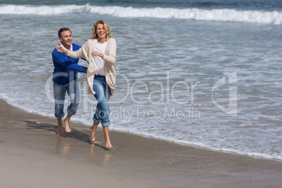 Mature couple enjoying on the beach