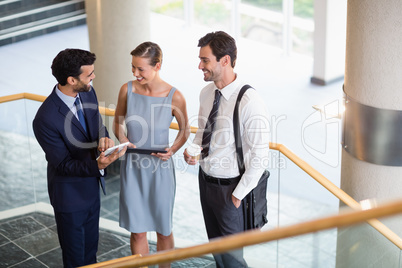 Business executives discussing over digital tablet