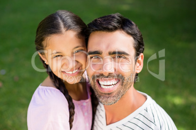 Father embracing her daughter in park