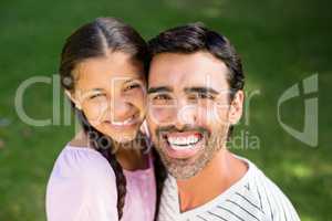 Father embracing her daughter in park