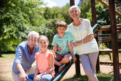 Portrait of grandparents playing with their grandchildren in park