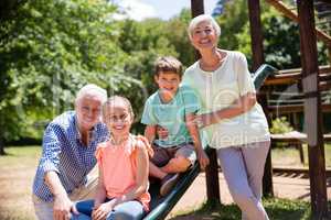 Portrait of grandparents playing with their grandchildren in park