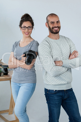 Photographers with digital camera standing in studio