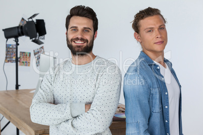 Smiling photographers standing in studio