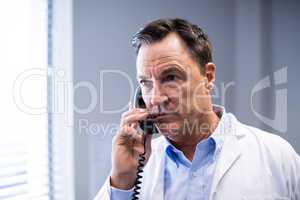 Male doctor interacting on phone