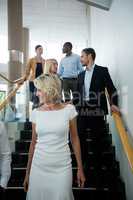 Business executives walking down the stairs