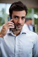 Male business executive talking on mobile phone