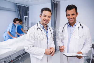Portrait of two doctors standing with medical report