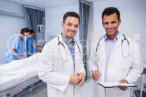 Portrait of two doctors standing with medical report