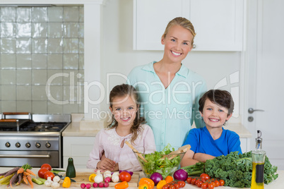 Portrait of mother and kids smiling in kitchen
