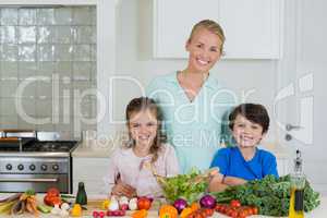Portrait of mother and kids smiling in kitchen