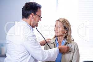 Doctor examining a female patient