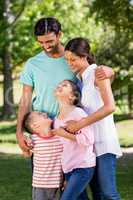 Happy family standing in park