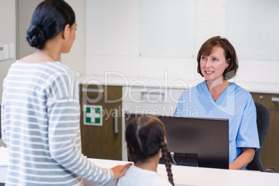 Nurse talking with a patient at counter