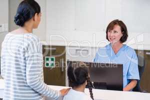 Nurse talking with a patient at counter