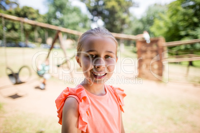Portrait of innocent girl smiling in park