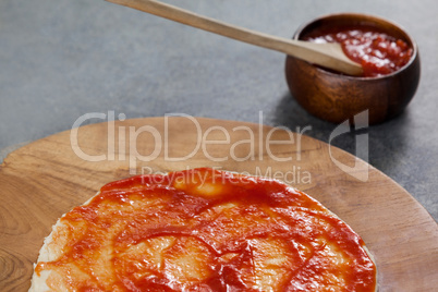 Pizza dough with tomato sauce