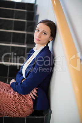 Worried businesswoman sitting on steps