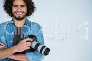 Happy male photographer standing in studio