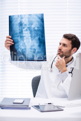 Male doctor examining x-ray