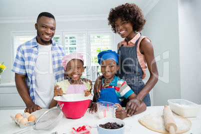 Parents and kids preparing food in kitchen at home