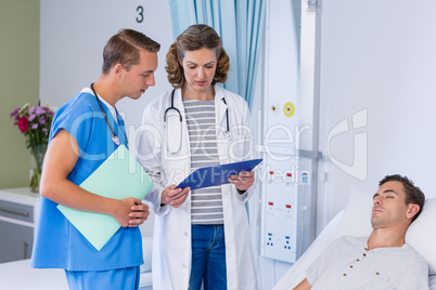 Doctors discussing with report