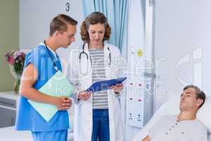 Doctors discussing with report
