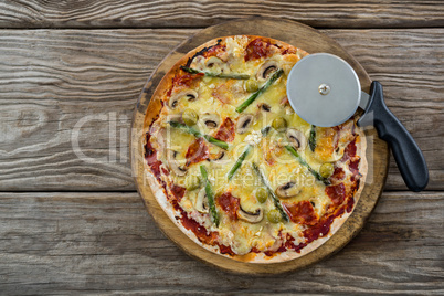 Italian pizza with pizza cutter on a tray