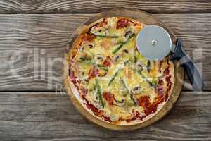Italian pizza with pizza cutter on a tray