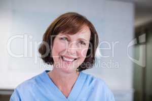 Smiling nurse sitting at desk