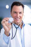 Portrait of male doctor holding stethoscope