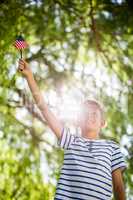 Boy holding small american flag