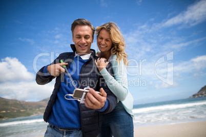 Mature couple taking selfie with selfie stick