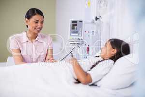 Nurse talking to a girl patient