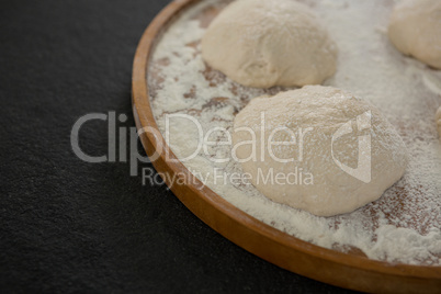 Bread dough ball on wooden tray