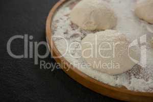 Bread dough ball on wooden tray