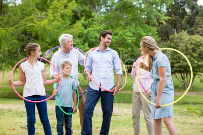 Multi-generation family holding hula hoop