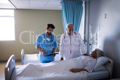 Doctor examining senior patient in the ward