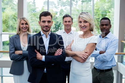 Business executives with arms crossed at conference center