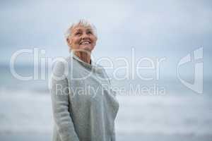 Senior woman standing on the beach